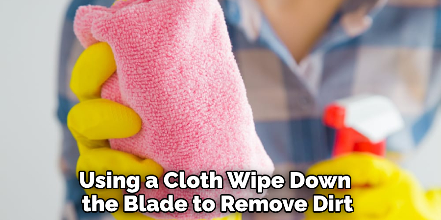 Using a Cloth Wipe Down the Blade to Remove Dirt