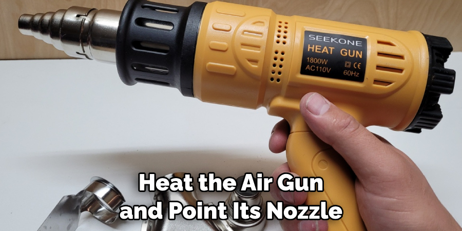 Heat the Air Gun and Point Its Nozzle